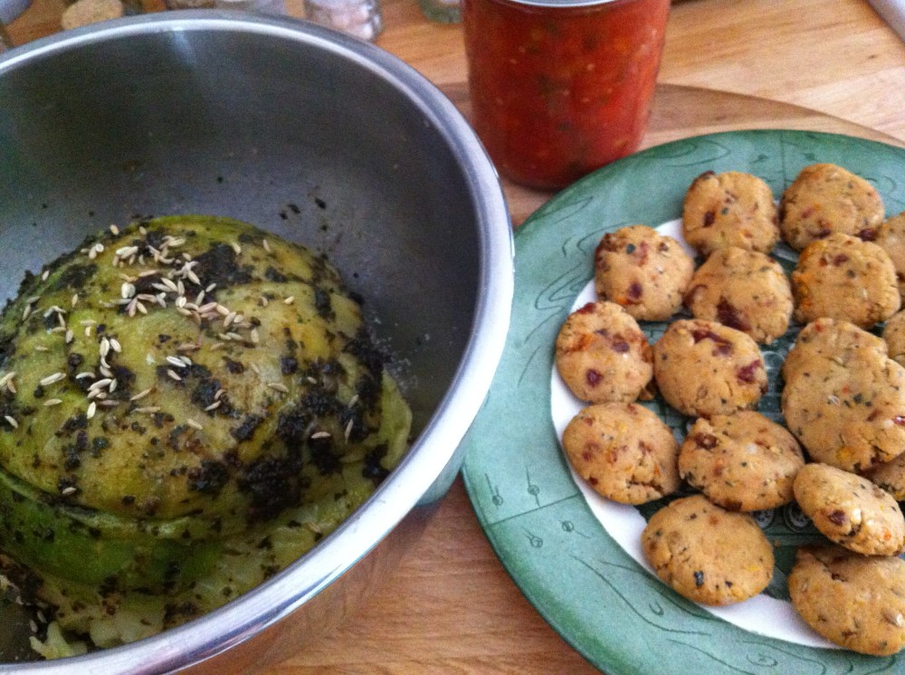 Stuffed cabbage ready to braise, with a plate of tempeh sausage patties alongside