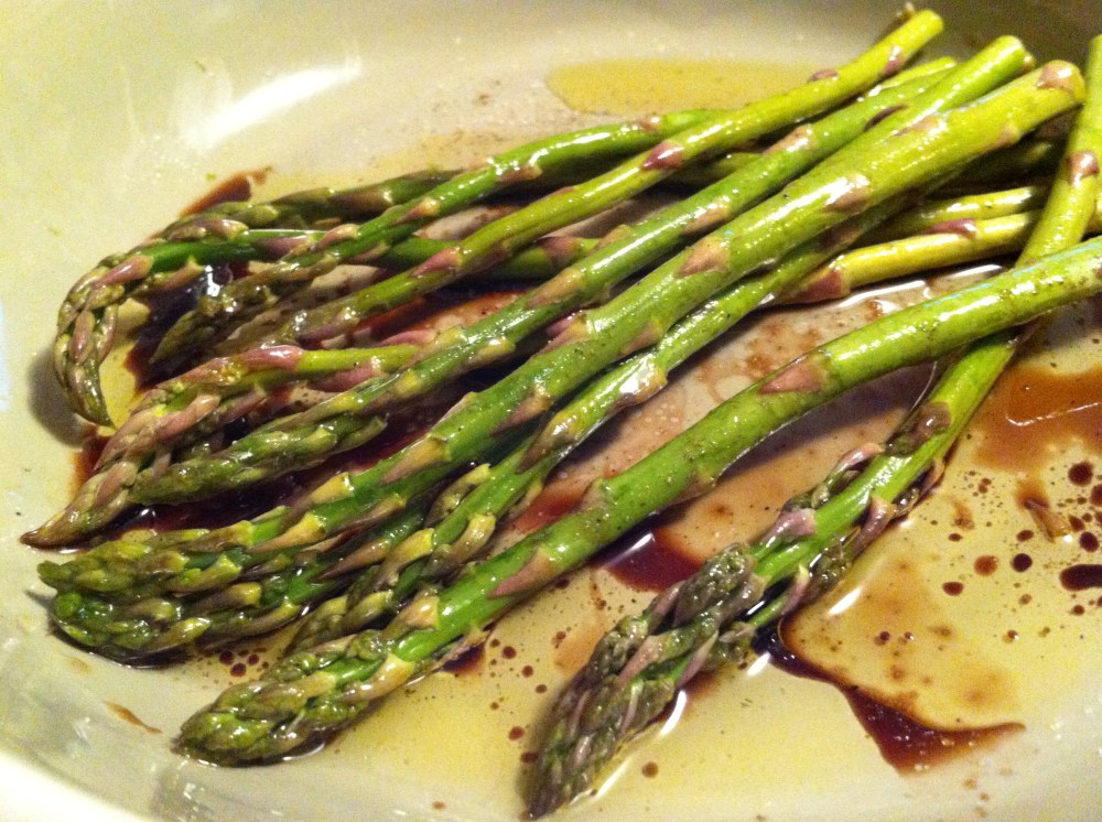 marinating asparagus in balsamic vinegar and olive oil